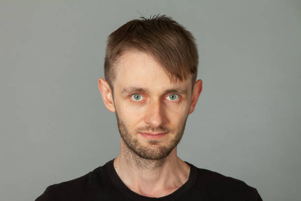 istock Close up studio portrait of 30 year old bearded man on gray background 1357197607