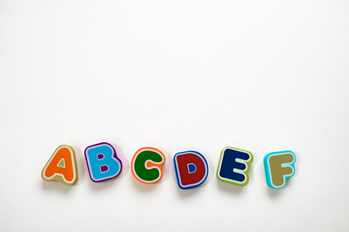 Colorful alphabet letters on a white background. Flatlay and isolated. School or learning to spell concept.