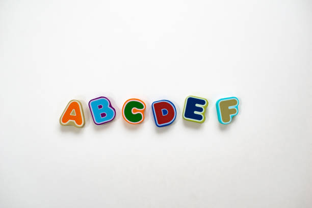 Alphabet colorful letters on a white background Alphabet begining letters in a line on a white background. Learning to read and spell. ABCDEF as colorful wooden toys for kids. Flat lay or top view. magnetic letter stock pictures, royalty-free photos & images