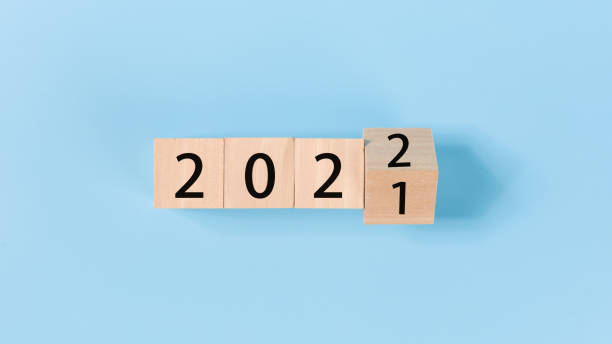 istock woodblocks cubes with a number 2021 change to 2022 blue background. 1357200628