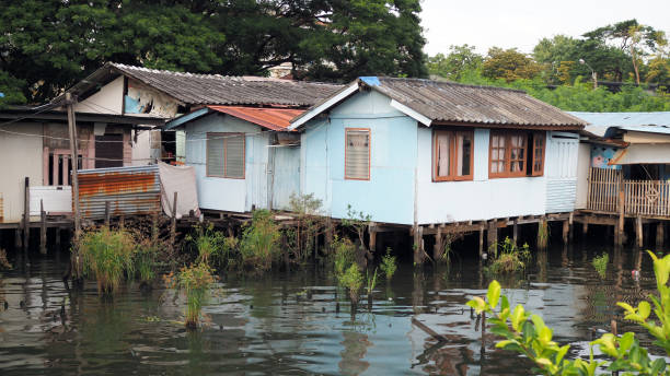 istock Water front city house slum river 1357201199