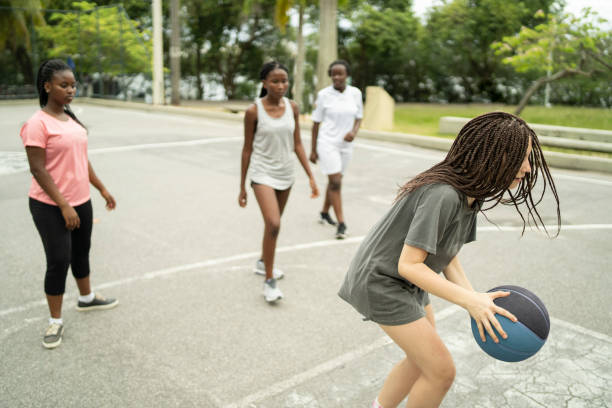 istock Diverse high school female basketball team playing a game 1357206845