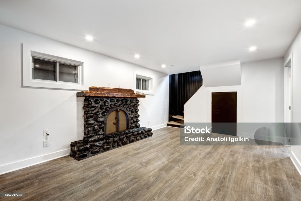 Canadian house in Montreal's suburb Typical budget Canadian single family house, renovated with some luxury elements in design partially furnished with kitchen, rooms, bedrooms, bathrooms, appliances, finished basement, fireplace, laundry, backyard and patio Basement Stock Photo