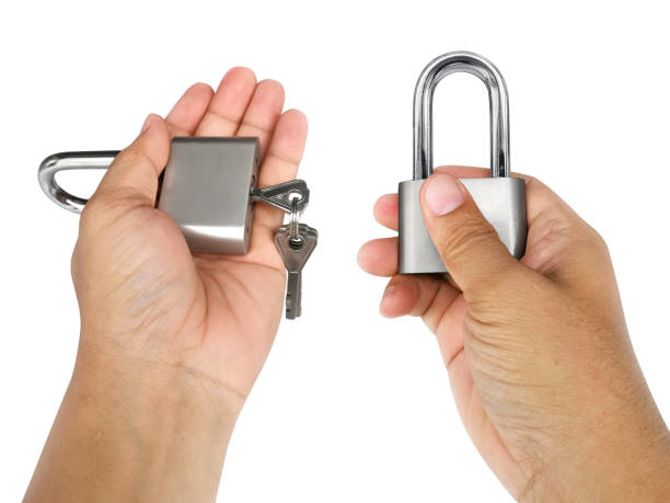 istock Padlock in hands on isolated white background 1357213785
