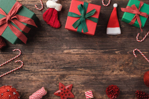 istock Christmas gift box and pine cone ,candy cane decoration ornament on table wood background 1357214616