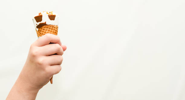 istock kid eating ice cream wafer cone with happiness 1357216407