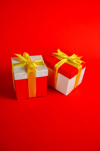 istock Two red white gift box packages with gold ribbon 1357218750