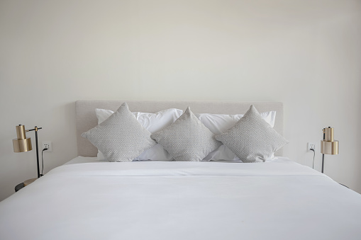 Shot of clean pillows neatly arranged on a double bed.