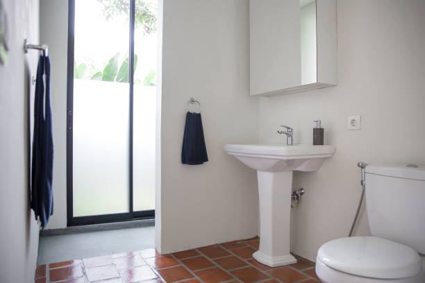 Clean Domestic Bathroom Shot of a clean domestic bathroom .There's a soap dispenser on a sink and a clean new towel hanging nearby. powder room stock pictures, royalty-free photos & images