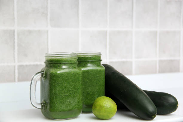 istock Green juice made from vegetables such as cucumber, lemon, spinach, chard, celery served in a glass mason jar for a healthy, vegan and nutritious breakfast 1357224819