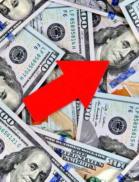 American Dollars Background with a Red Arrow Up