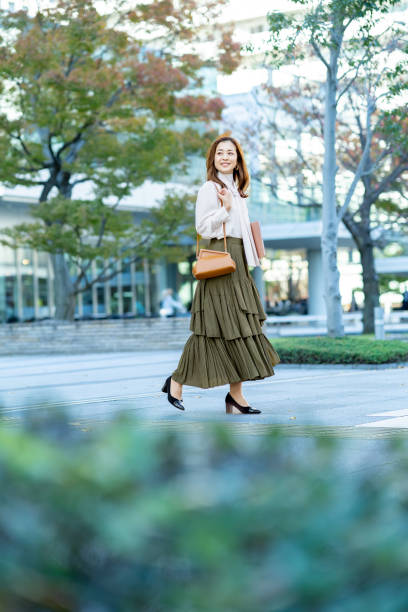 istock woman commuting in office casual style 1357229700