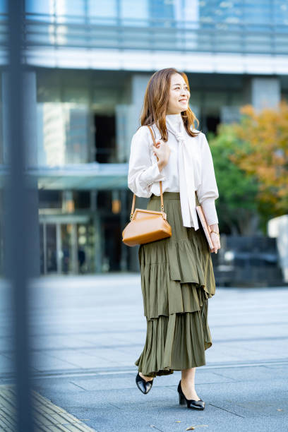 istock woman commuting in office casual style 1357229857