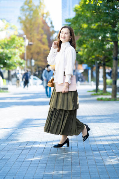 istock woman commuting in office casual style 1357229941