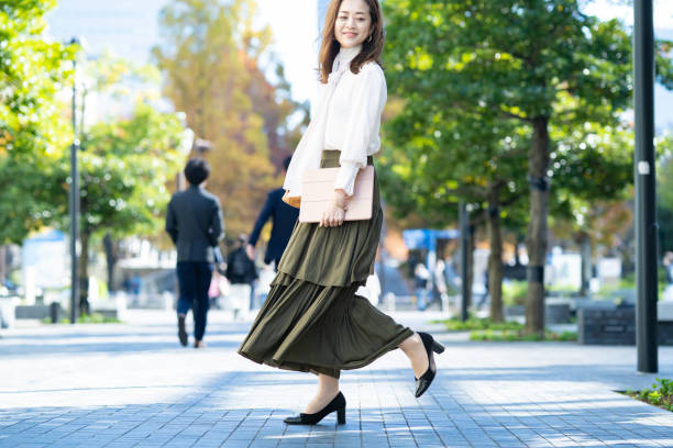 istock woman commuting in office casual style 1357229958