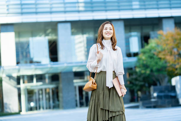 istock woman commuting in office casual style 1357229971
