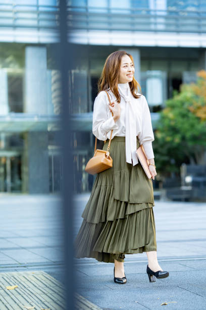 istock woman commuting in office casual style 1357230544