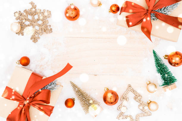 istock Christmas frame. Winter wooden decoration background. Xmas board with old rustic wall, white frozen snow, golden balls and gift box. Top view with copy space. 1357230590