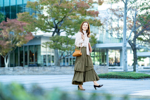 istock woman commuting in office casual style 1357230759