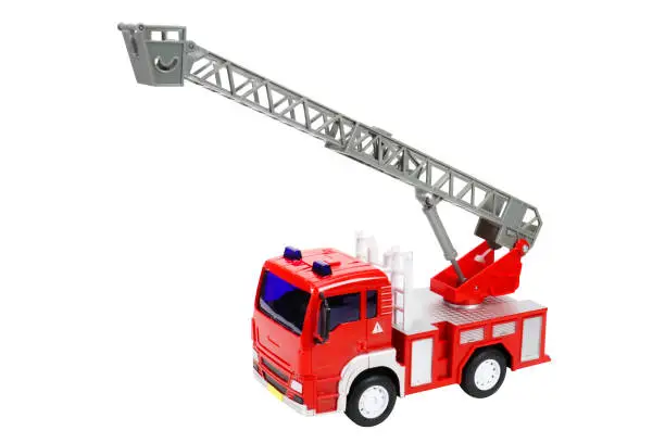 Photo of Red toy fire truck with ladder, on white background, isolated image