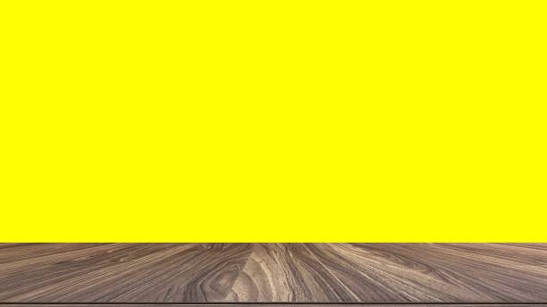 istock Wood table on yellow background 1357233642