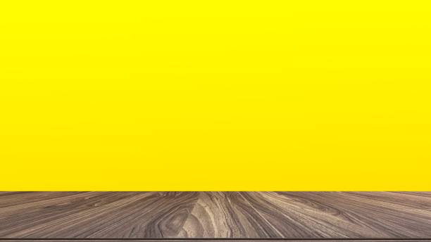 istock Wooden table on yellow background 1357233652