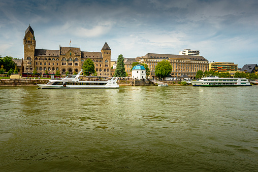 Koblenz, Germany - August 12, 2021: Prussian government building ( Preussisches Regierungsgebäude ) and some tourboats in Koblenz