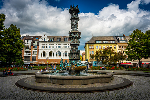 Koblenz, Germany - August 10, 2021: Famous fountain with history column sculpture at the Gorresplatz square in Koblenz