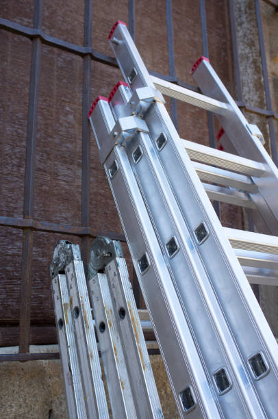 istock Professionals ladders folded stand over old town building 1357241604
