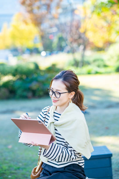 istock a woman using a tablet PC outdoors 1357244418