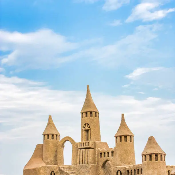 Sandcastle during a sunny day with blue sky background. Concept for summer, vacation, relax and fun.