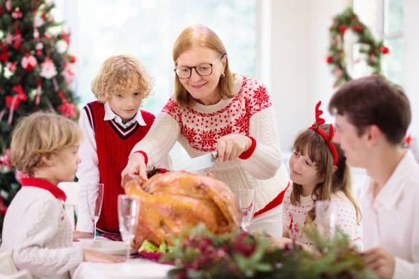 istock Christmas dinner. Family with kids at Xmas tree. 1357246440