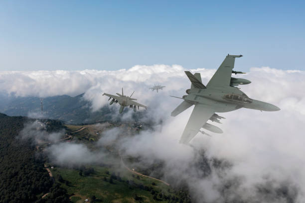 istock Jet fighters flying over the clouds. 1357249465