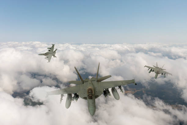 istock Jet fighters flying over the clouds. 1357249616