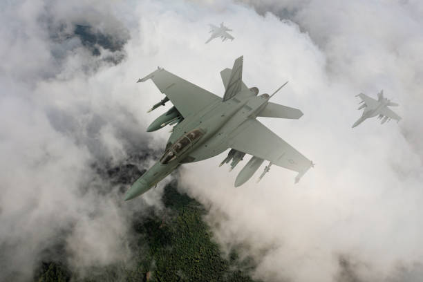istock Jet fighters flying over the clouds. 1357250287