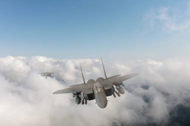 istock Jet fighters flying over the clouds. 1357250599