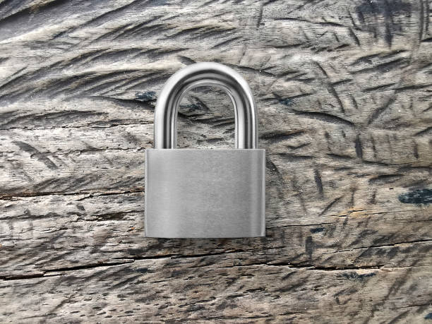 istock Locked Padlock on vintage wood texture background 1357252329