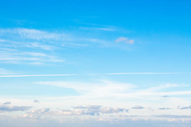 white fluffy clouds on a deep blue sky stock photo