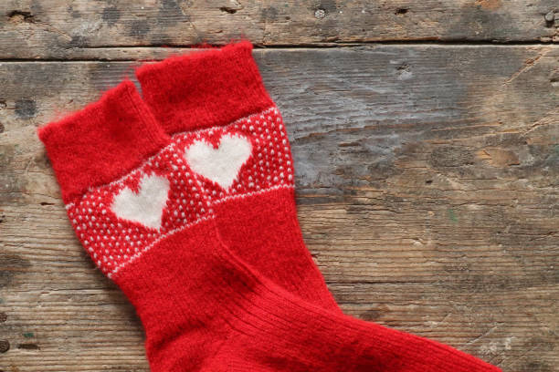 istock Red christmas socks on wooden table 1357254880