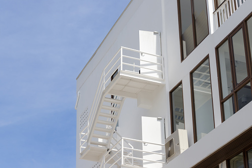 fire escape stair steel. white outdoor metal stair of building.