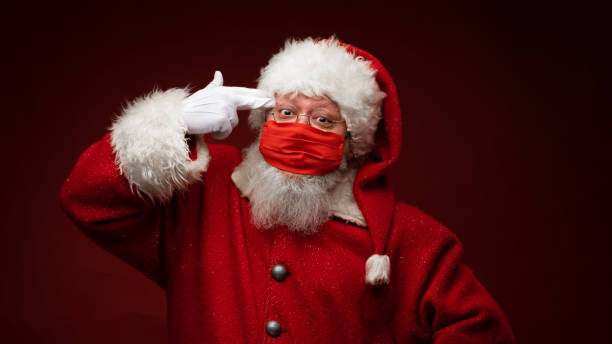istock Santa Claus tired of protective mask 1357255173