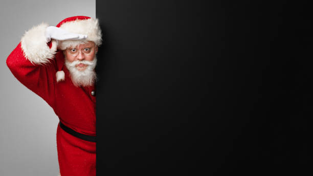 istock Santa Claus look to future black banner 1357255177