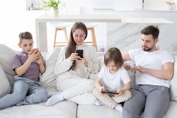istock Parents and kids use devices together 1357255793