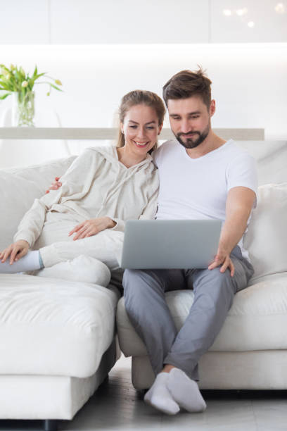 istock Couple browsing internet in living room 1357255804