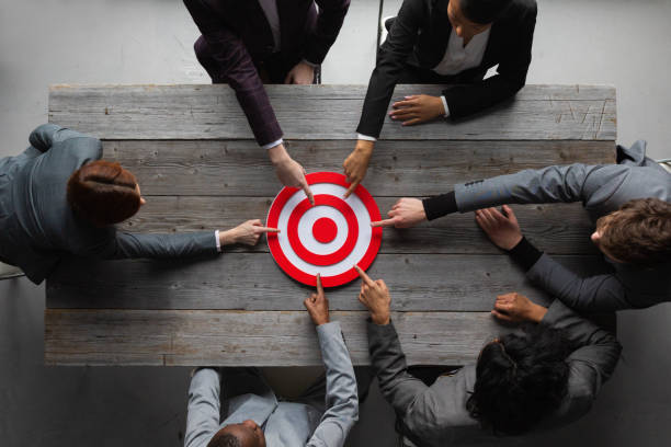istock Business people pointing at target 1357255864
