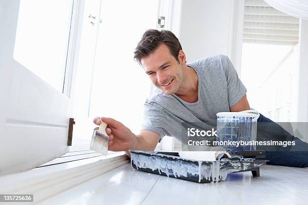 Man Decorating House Stock Photo - Download Image Now - 30-39 Years, Adult, Adults Only