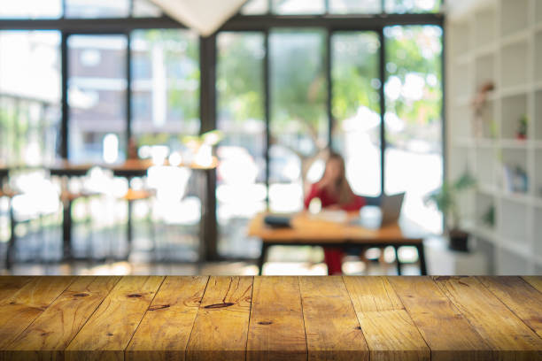 istock Empty wood table with blur cafe or coffee shop background. 1357259513