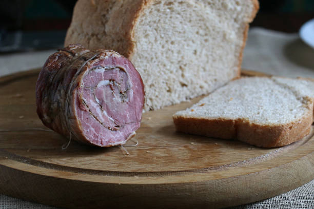 istock Smoked meat on a wooden kitchen board. 1357260371