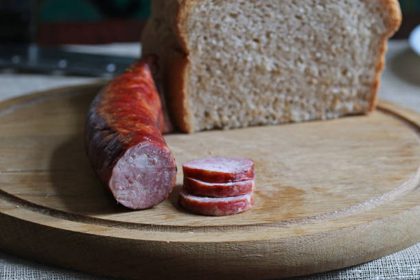 istock Smoked meat on a wooden kitchen board. 1357260372