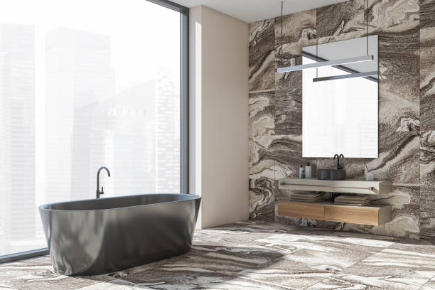 istock Bathroom interior with sink and mirror, bathtub near window 1357261456